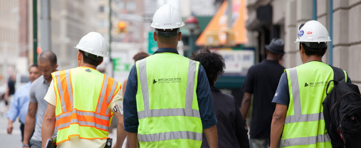 Behind view of construction workers